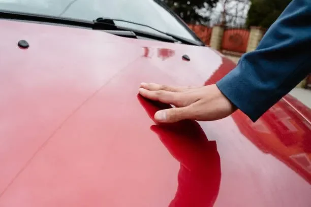 Paint surface being wiped with a microfiber cloth