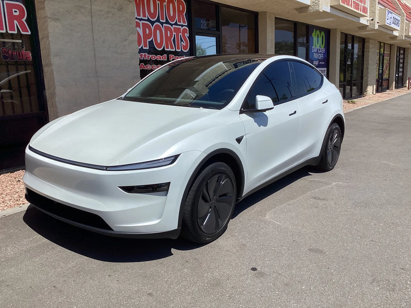 White Tesla with tinted windows outside Superior’s Ontario shop